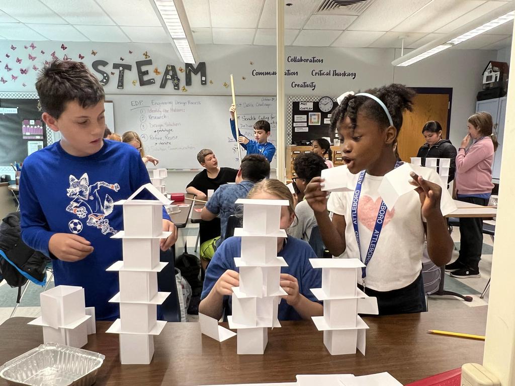 Students building structures with index cards
